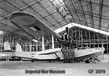 Aircraft Picture - Royal Air Force mechanics inspecting a H6K at Soerabaja, Java, prior to a test flight in January 1946. Note the Indonesia flag added by nationalists and the additional blue band added to the fuselage marking by the Dutch