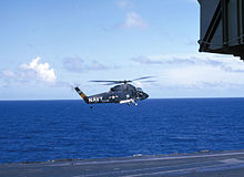 Aircraft Picture - A UH-2A on plane guard duty hovers over the USS Kitty Hawk in March 1966