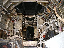 Airplane Picture - Inside Wk Nr 701152 He 111 H-20. Looking forward to the first bulkhead from the ventral gunner's position. The control column and cockpit glazing is visible in the central background