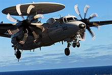 Airplane Picture - A US Navy E-2C of VAW-117 approaches to land on the flight deck of the USS John C. Stennis (CVN-74), clearly showing the new eight-bladed propellers being installed on all of the Navy's E-2Cs