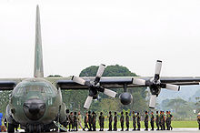 Airplane Picture - Philippine Air Force and Army servicemen unload a C-130 of supplies for transfer to waiting U.S. helicopters for delivery to Panay Island.