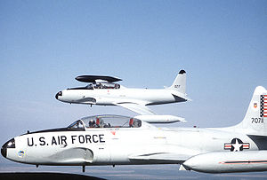 Warbird Picture - Two T-33s from the 95th Fighter Interceptor Training Squadron in flight near Tyndall AFB, Florida. The farther aircraft has been repainted and renumbered in anticipation of its delivery to the Mexican air force.