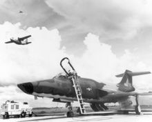 Airplane Picture - U.S. Air Force technicians prepare a McDonnell RF-101 Voodoo for a photo reconnaissance mission