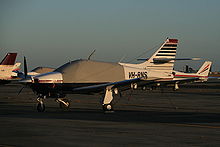 Airplane Picture - A late-model Commander 114; with a different-shaped engine cowling and fresh-air inlet in the leading edge of the tail fin (seen in this photo with a red plug to prevent birds entering) compared to early-model aircraft