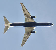 Airplane Picture - Planform view of a British Airways 767-300 after take off, with retracted landing gear and partially deployed flaps.