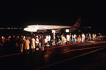 Airplane Picture - Spectators watch one of two C-137B Stratoliner aircraft returning freed hostages after their release from Iran in 1981