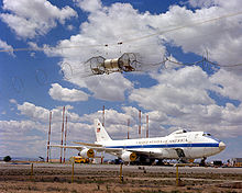 Airplane Picture - A right front view of an E-4 advanced airborne command post (AABNCP) (AF Serial No. 75-0125) on the electromagnetic pulse (EMP) simulator for testing.