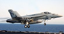 Airplane Picture - A U.S. Navy F/A-18E above the deck of USS Abraham Lincoln in 2002