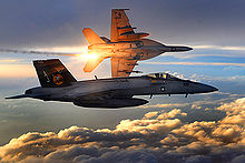 Airplane Picture - Two U.S. Navy F/A-18 Super Hornets fly a combat patrol over Afghanistan in 2008. The aircraft banking away in the background can be seen launching infra-red countermeasure flares.