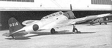 Airplane Picture - A B5N1 Kate parked in front of a hangar.