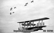 Airplane Picture - Short Singapore III flying boat of 205 Squadron, in flight below three 'vic' formations of Vickers Vildebeest torpedo bombers of 100 Squadron, both units were based at RAF Seletar.