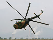 Airplane Picture - Macedonian Air Force Mi-17 performing a very tight low-level right turn. The power plant REK Bitola can be seen in the background.