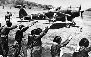 Airplane Picture - A Ki-43 III-Ko, piloted by Second Lieutenant Toshio Anazawa and carrying a 250 kg (550 lb) bomb, sets off from a Japanese airfield for the Okinawa area, on a kamikaze mission, 12 April 1945. School girls wave goodbye in the foreground.