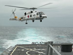 Warbird Picture - A JMSDF SH-60J Seahawk helicopter from JS Haruna (DDH 141) lands onboard USS Russell (DDG 59) in 2007.