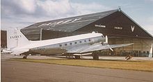 Airplane Picture - Fairey Air Surveys Douglas DC-3 outside Fairey's 1937-built hangar at Manchester Airport during servicing in 1975