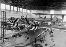 Airplane Picture - Catalina Is of 205 Sqn. RAF undergoing service in their hangar at Seletar, Singapore.