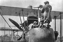 Airplane Picture - An F.E.2d observer demonstrating the use of the rear-firing Lewis gun which required him to stand on his seat.