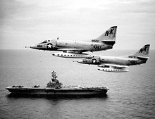 Aircraft Picture - VA-146 A-4Cs over the Gulf of Tonkin in August 1964. USS Kearsarge (CV-33) steams below.