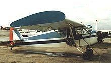 Aircraft Picture - Piper J-5A Cub Cruiser with wing endplates and banner-towing gear at North Perry airport, Florida, in March 1987