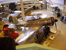 Aircraft Picture - Another view of the VL Pyorremyrsky (behind the pole, next to a Messerschmitt Bf 109) with a Valmet Vihuri in the foreground.