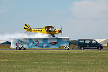 Aircraft Picture - Piper J3C-65 lands on a moving trailer at Cotswold Airport, Gloucestershire, England, in 2010. This aircraft is shown in closeup above.