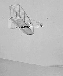 Aviation History - The Wright Brothers - Wilbur Wright pilots the 1902 glider over the Kill Devil Hills, October 10, 1902. The single rear rudder is steerable; it replaced the original fixed double rudder.