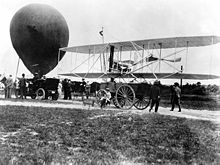 Airplane Picture - The Wright 1908 Model A Military Flyer arrives at Fort Myer, Virginia aboard a wagon, attracting the attention of children and adults.