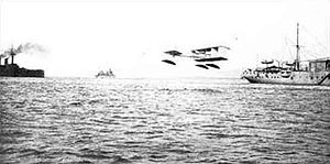 Aviation History - Gabriel Voisin - The first seaplane carrier, the French La Foudre (right, with hangar and cr ane), with one of her Canard Voisin seaplanes, the first operational seaplanes, during tactical exercises in June 1912.