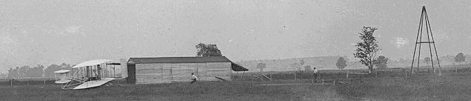 Airplane Picture - Start of the first flight of Flyer III, June 23, 1905, Orville at the controls. The catapult tower, which they began using in September 1904, is at right. It helped accelerate the aircraft to takeoff speed. The Flyer looks virtually identical to the previous two powered versions, but noticeably different from its later appearance, after the Wrights extended and enlarged the elevator and rudder. The two men are probably Wilbur (running behind the airplane) and Charles Edward Taylor (at right), the Wrights' mechanic who built their first aircraft engine.