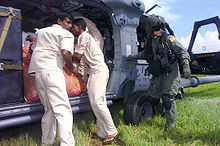 Helicopter Picture - Sri Lankan relief workers unload vegetables from an HH-60G during an Operation Unified Assistance mission.