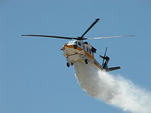 Helicopter Picture - Los Angeles County Fire Department's S-70A Firehawk during a water drop demonstration at Station 129 in Lancaster, California