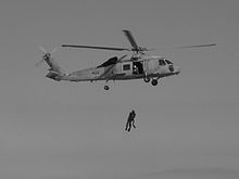 Helicopter Picture - SH-60F Seahawk hoisting up a SAR swim pair