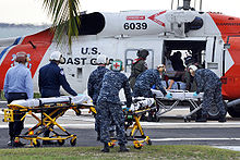 Helicopter Picture - Victims from the 2010 Haiti earthquake are unloaded from a HH-60J Jayhawk (USCG Registration Number 6039) at U.S. Naval Hospital Guantanamo Bay, Cuba.