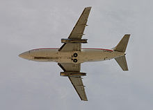 Airplane Picture - Boeing 737-200 Adv planform and exposed landing gear tires are visible on this USAF T-43 takeoff. The rather thin JT8D engines extend past the leading and trailing edges.