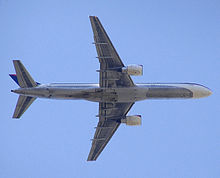 Airplane Picture - Planform view of Delta Air Lines 757-200 after take off, with retracted landing gear and partially deployed flaps.