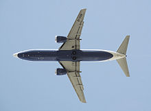 Airplane Picture - Transaero 737-400 in planform view at takeoff. The stubbier CFM56 engines are mounted ahead of the wings.