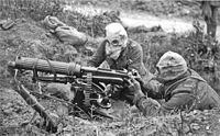 World War 1 Picture - British Vickers machine gun crew wearing PH gas helmets with exhaust tubes.