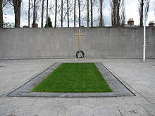 World War 1 Picture - The burial spot of the Leaders of the Rising, in the old prison yard of Arbour Hill prison. The memorial was designed by G. McNicholl. The Proclamation of 1916 is inscribed on the wall in both Irish and English