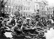 World War 1 Picture - British troops from 4th Royal Fusiliers resting in the square at Mons 22 August 1914, the day before the Battle of Mons