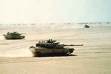 World War 1 Picture - A combined force of M1 Abrams tanks, Bradley IFVs and a logistical convoy advancing during the Gulf War