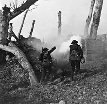 World War 1 Picture - Two U.S soldiers run toward a bunker past the bodies of two German soldiers during World War I. Digitally restored.