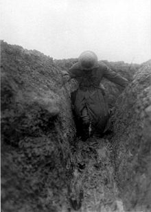 World War 1 Picture - Bean in the mud of Gird Trench near Gueudecourt, Somme, France, during the winter of 1916-17