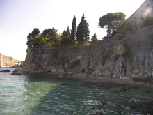 World War 1 Picture - The Garden of the People at Palaia Anaktora from the sea. The spiral staircase is visible on the left. Kontrafossa and the bridge to Palaio Frourio on the left of the picture.