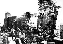 World War 1 Picture - French troopers under General Gouraud, with their machine guns amongst the ruins of a cathedral near the Marne, driving back the Germans. 1918