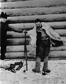 World War 1 Picture - A Bolshevik soldier shot by an American guard at Outpost No. 1 at 3:00 a.m. on the morning of Jan. 8, 1919 when an enemy patrol of 7 men attempted to creep up on the outpost position. This picture was taken to show the white cloak, which all the members of the patrol wore to conceal their movements in the snow. The clothing worn by the man was warm and in good condition. He carried, in addition to a hand grenade, which lies on the ground, a Remington rifle, in good condition, and a plentiful supply of ammunition. Village of Visorka Gora, Russia. Jan. 8, 1919. (from the U.S. Army Signal Corps official photo caption).