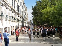 World War 1 Picture - A marching band from Austria, a frequent visitor, through the Corfu landmark of Liston (it). In the background the western arch of Palaia Anaktora.