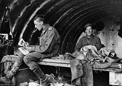 World War 1 Picture - Gunners Baker and Harrison of the 16th Battery relax in a dugout c. 1916