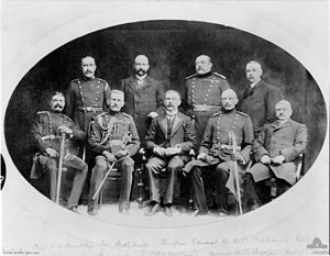 World War 1 Picture - Group portrait of Commonwealth Headquarters Staff. Identified left to right, back row: Captain P. N. Buckley; Mr S. Petherbridge; Surgeon General W. D. C. Williams; Mr F. Savage. Front row: Colonel H. Le Mesurie; Colonel J. C. Hoad; Lieutenant Colonel J. W. McCay; Colonel W. T. Bridges, Mr J. A. Thompson.
