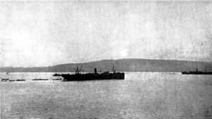 World War 1 Picture - The sun rising over Chunuk Bair, Gallipoli peninsula, on the morning of 25 April 1915 during the landing at Anzac Cove. In the centre of the photo is SS Novian carrying the headquarters of the 2nd Infantry Brigade. At the right is the SS Galeka from which the brigade's 6th and 7th Infantry Battalions have been landing.