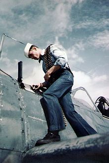 World War 1 Picture - US Navy Ordnance man loads guns of a F2A fighter, 1943.